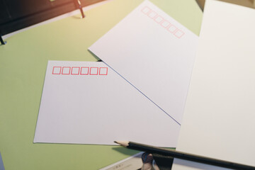Blank Postcards and Pencil on Green Background, Ideal for Personal Messages and Creative Projects, Stationery Concept