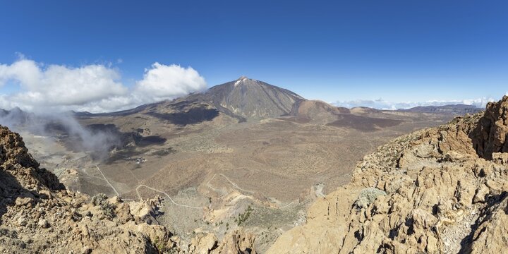 Panorama during the ascent to Alto de Guajara, 2715m, to the bizarrely shaped rock formations of volcanic rock, Roques de Garc&iacute;a, the visitor centre and the Hotel Parador, behind it the Pico del Teide, 3717m, Teide National Park, Parque Nacional del Teide, Tenerife, Canary Islands, Spain