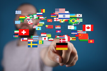 Person pointing to a network of international flags, symbolizing global connection, unity, and communication. Represents diversity, internationa