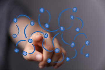 A human hand interacts with a futuristic digital network overlay, symbolizing global connections, data exchange, and modern technology.