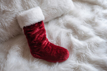 Red stocking plush white fur cozy festive joy on soft rug