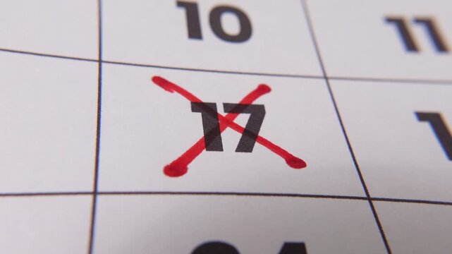 Highlighting date number 17 on a calendar, with a bold red cross mark emphasizing an important reminder or scheduled event.
