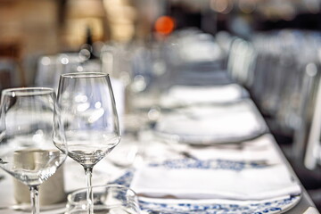 Empty wine glasses on a set, formal dinner table. Close up shot, shallow depth of field, no people