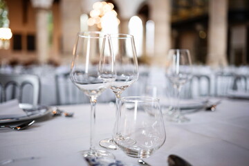 Empty wine glasses on a set, formal dinner table. Close up shot, shallow depth of field, no people