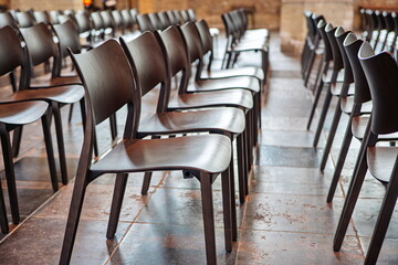 Empty, wooden church chairs inside protestant church, no people