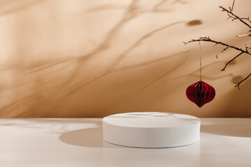 Product podium with Christmas paper ball at the background and aesthetic tree branch shadows. Showcase with copy space for product presentation, gift and design. Christmas and New Year background