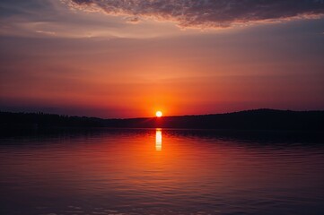 Naklejka premium Sunset Silhouette Mirrored on the Water Surface