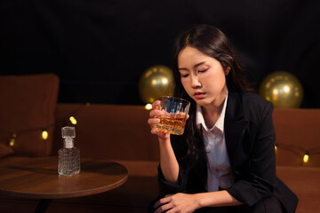 Closeup business woman holding a glass of whiskey