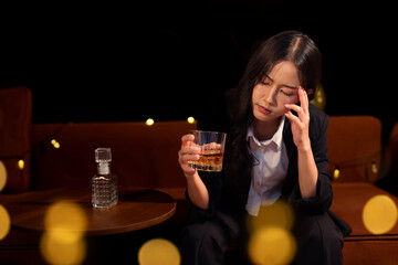 Closeup business woman holding a glass of whiskey