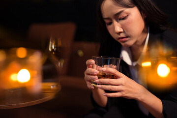 Closeup business woman holding a glass of whiskey