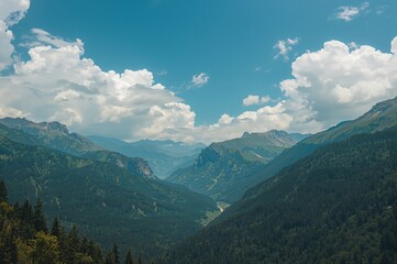 Obraz premium Mountain scenery under a bright blue sky with fluffy white clouds during summer