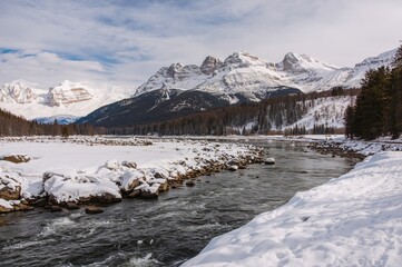 Breathtaking view of a snowy riverside park adorned with rocks