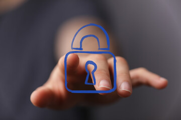 Image of a hand selecting a digital lock icon, representing data security, privacy, and protection.