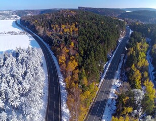Autumn road through snowy forest
