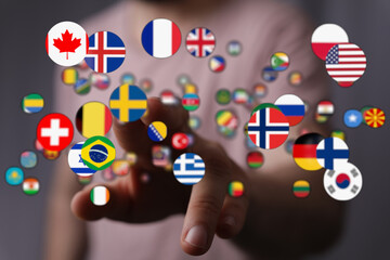 A person reaching out to a network of flags, symbolizing global connection, international...