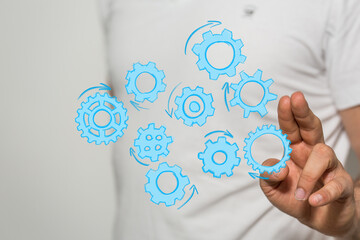 Abstract image of a man interacting with gears, symbolizing teamwork, collaboration, and workflow.