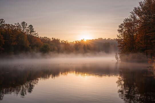 Dawn breaking over a tranquil body of water