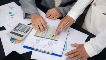 Close up businesswomen analyzing financial spreadsheet and data chart for planning
