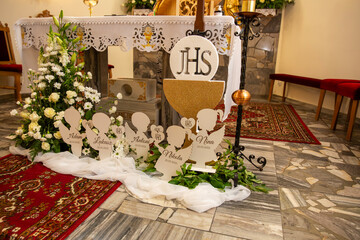 First Holy Communion altar in a Catholic church. Decorated with flowers.