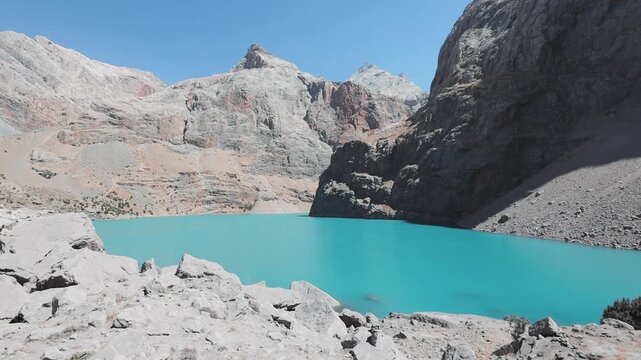 Big Allo lake view with mountain range and turquoise water in Fann mountains Pamir Alay Tajikistan
