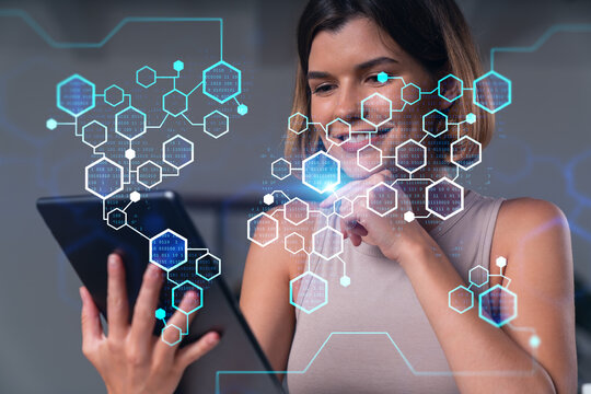 Woman using digital tablet with futuristic blue hexagonal interface overlay concept on technology and innovation background indoors..
