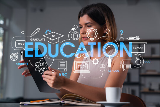 Woman using digital tablet with education concept graphics overlay in modern interior workspace environment for online learning and knowledge development.