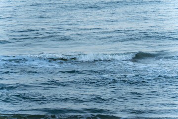 Gentle waves break on the shore. The movement of the sea has a calming and rhythmic effect.