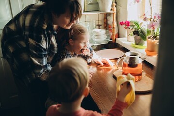 Mother and children spending time together in kitchen