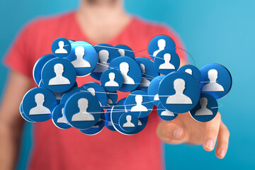 Conceptual social network image depicting a man interacting with digital profile icons, symbolizing global communication and connection.