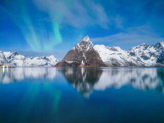 Aurora Borealis in Scandinavia. Norway, Lofoten islands. Northern lights over the mountains. Starry sky. Winter landscape on the north. Photo for background, wallpaper, postcards.