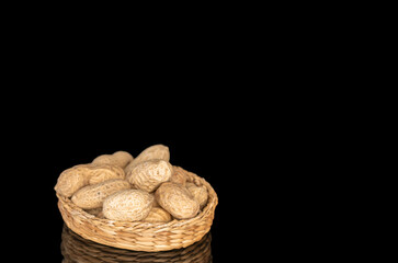 Unshelled peanuts isolated on black background, macro.