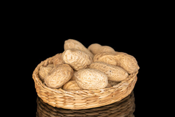 Unshelled peanuts isolated on black background, macro.