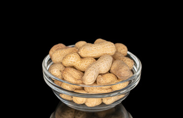 Unshelled peanuts isolated on black background, macro.
