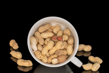 Unshelled peanuts isolated on black background, macro.