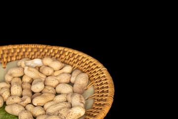 Unshelled peanuts isolated on black background, macro.
