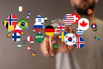 Concept image of a hand pointing at various world flags, representing global collaboration, unity, and cultural diversity. Suitable for internat