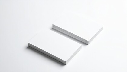 Stacked White Business Cards on White Surface under Soft Lighting