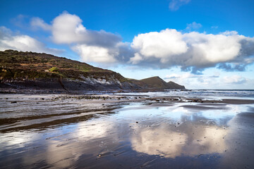 Sky reflections on wet sand at Crackington Haven Cornwall