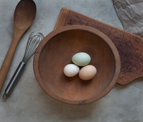Pastel Bantam Eggs with Rustic Wooden Items and Whisk