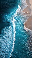 Stunning Aerial View of Turquoise Waves Crashing on Sandy Coast During Dramatic Sunset Over the Ocean