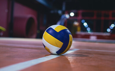 Volleyball on Indoor Court at Night, Sports Equipment Focus, Low Angle View, Gym Environment