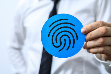 Image of a businessman holding a blue circle with a fingerprint icon.  Perfect for security,...