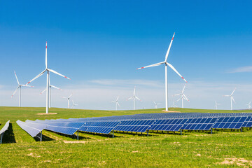 Ultra-realistic 8K image of wind turbines and solar panels in a large renewable energy field under blue sky
