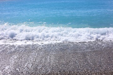 Fototapeta premium Beautiful view of wavy sea and pebbles on beach