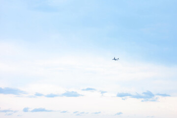 Airplane flying in beautiful blue sky, low angle view
