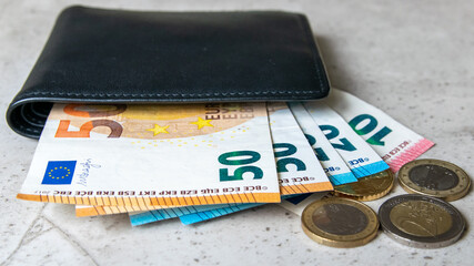 Leather partmone with money, euro coins and bills. Business concept.