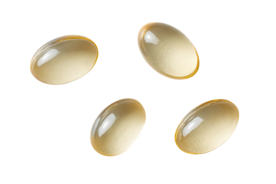 Four translucent light beige capsules, top view, isolated on black