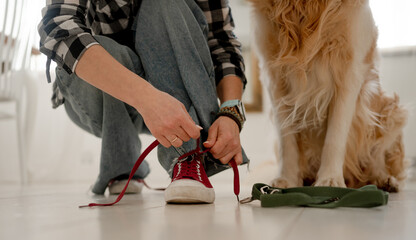 Girl Tying Shoelaces On Sneakers Before Walking With Dog