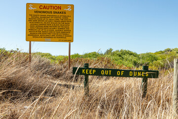 Warning sign of venomous dugite snakes at Swanbourne Beach near Perth in the SW Region of Western Australia WA