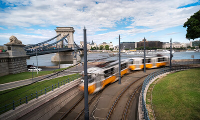 Tram Crossing Budapest Center With Chain Bridge Over Danube